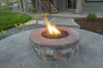 Outdoor stone fire pit with natural stone paver patio