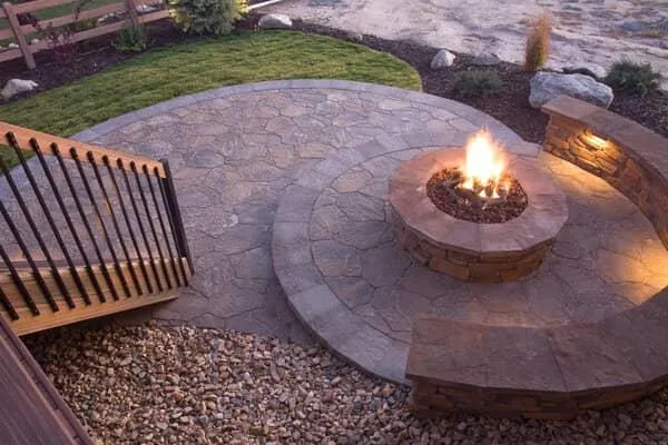 Outdoor stone fire pit with custom seating area