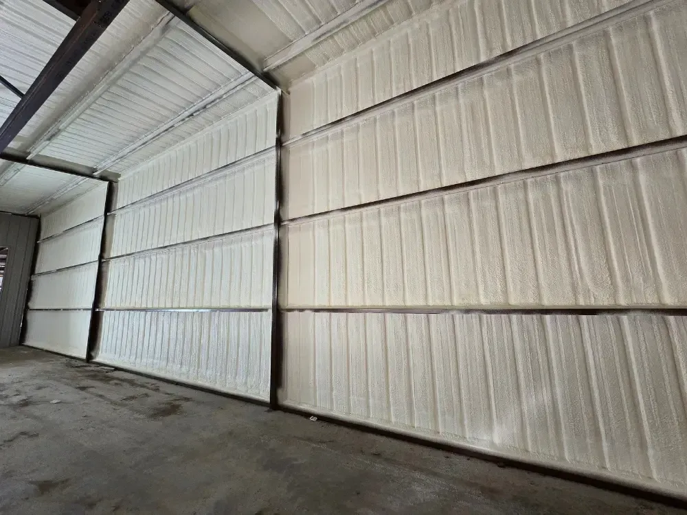 Closed-cell spray foam applied to metal garage walls for moisture resistance by 903 Spray Foam in Sumner, TX