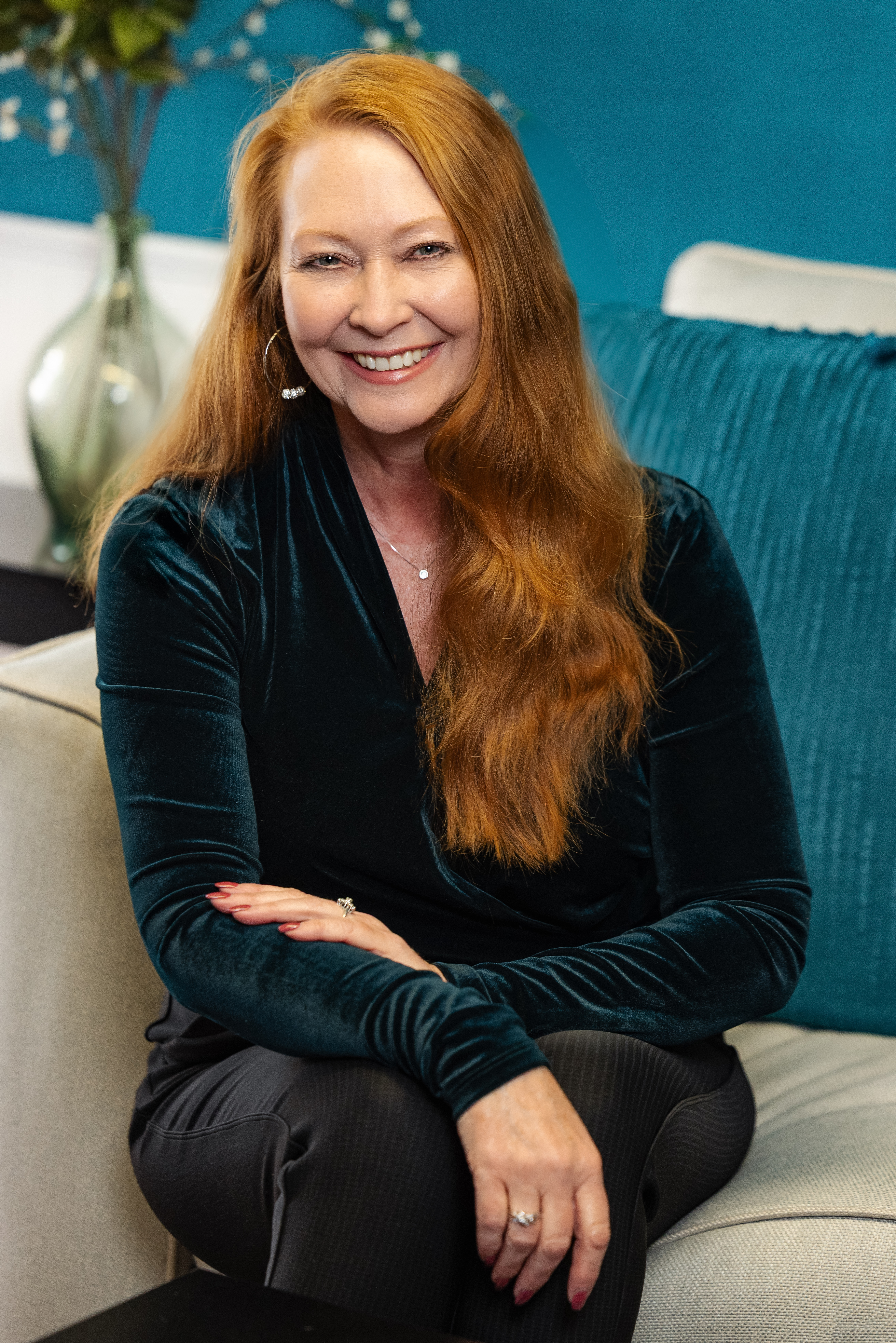 Charlene Richardson therapist in office smiling while holding notebook during counseling session