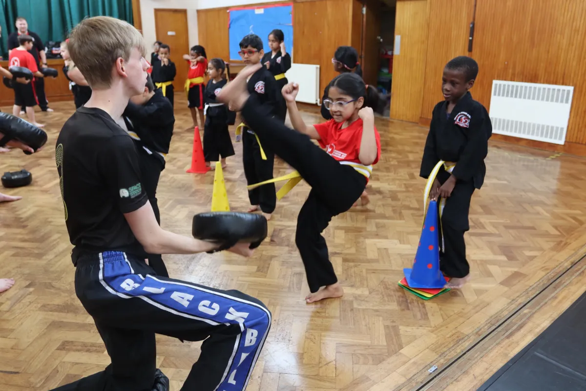 Kids aged 7–12 training martial arts with instructor at FSMA