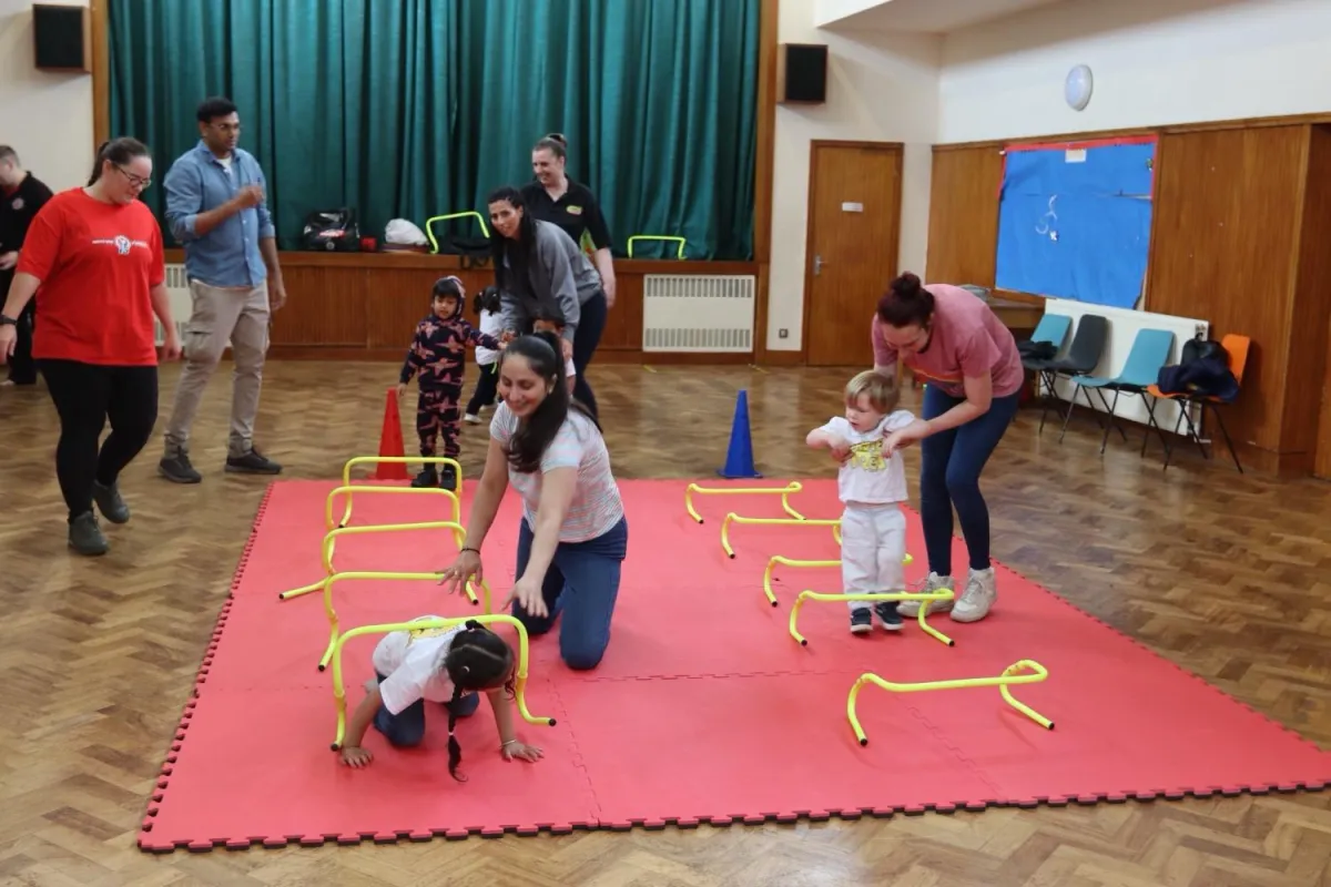 Toddler and parent training together in Monster Tots class
