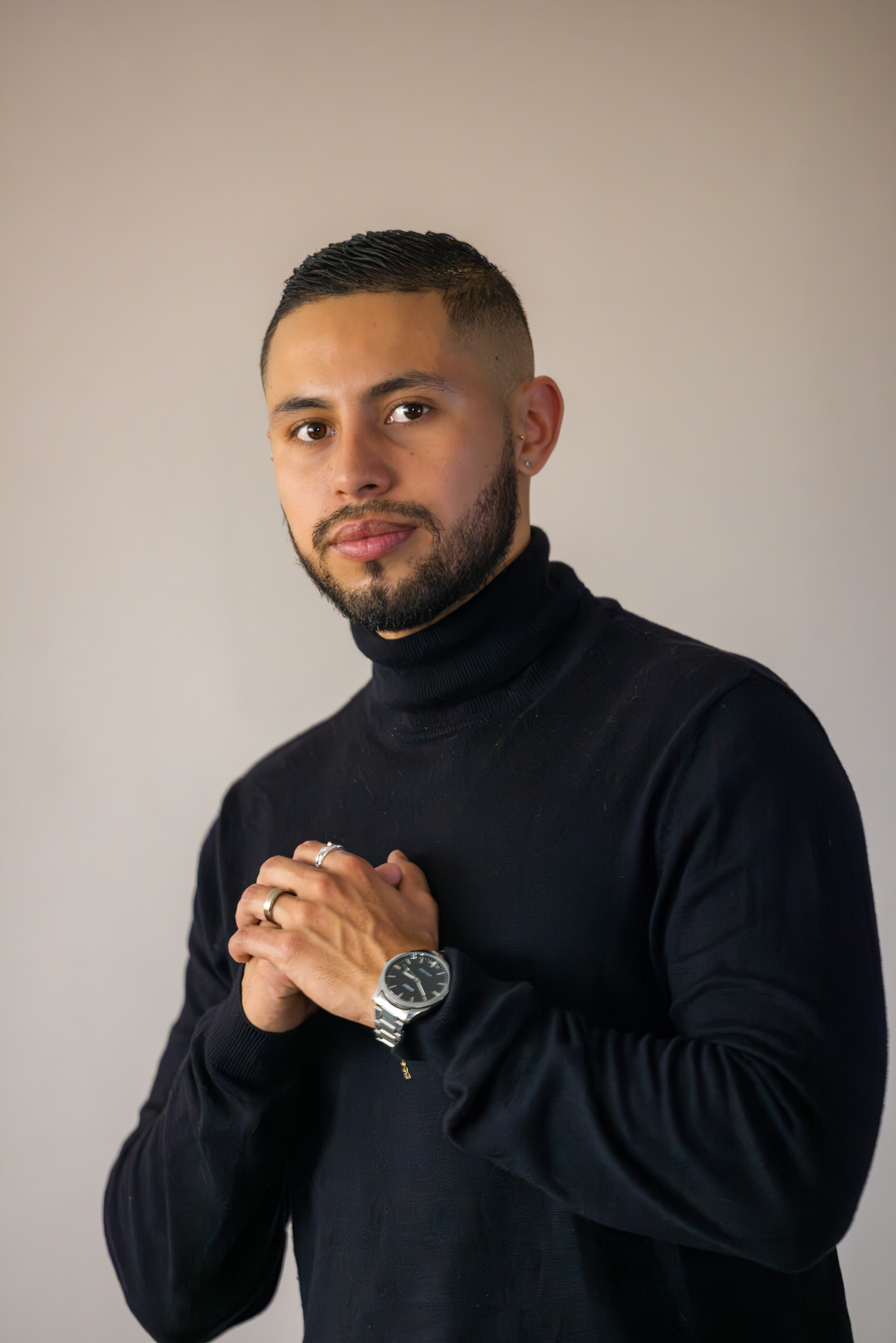 Woman posing confidently in a black suit during a professional studio portrait session