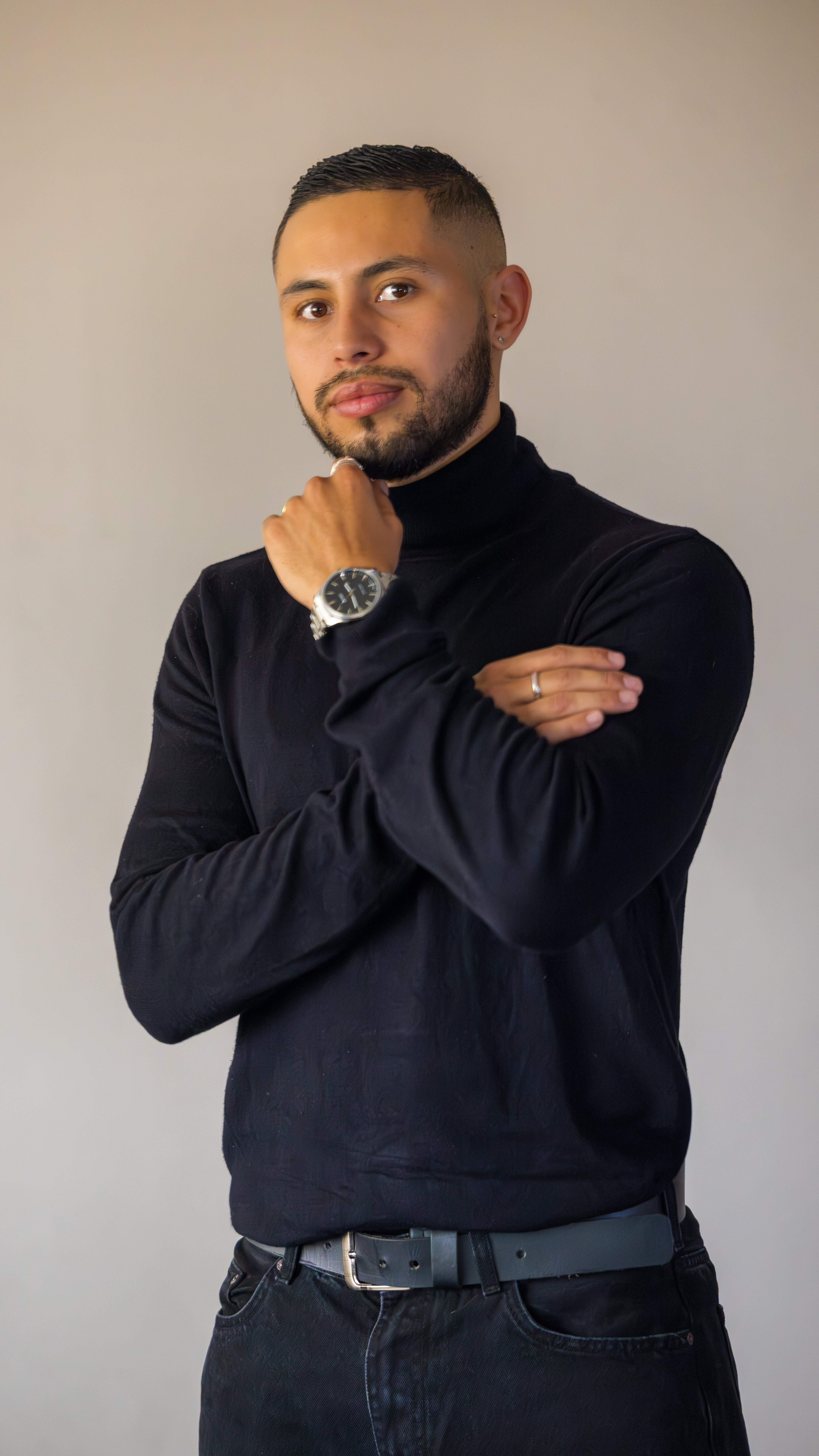 Woman standing in front of a vibrant street mural featuring a large painted face