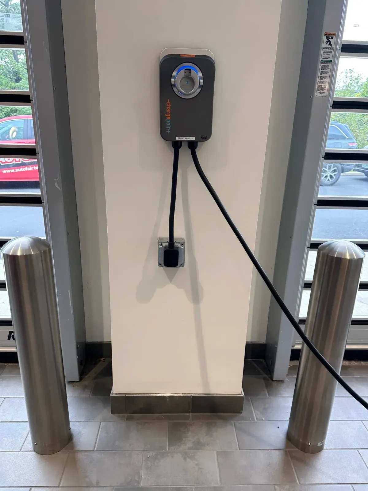Modern chandelier lighting installation by Ryan Gath Electric inside a residential home office with bookshelves