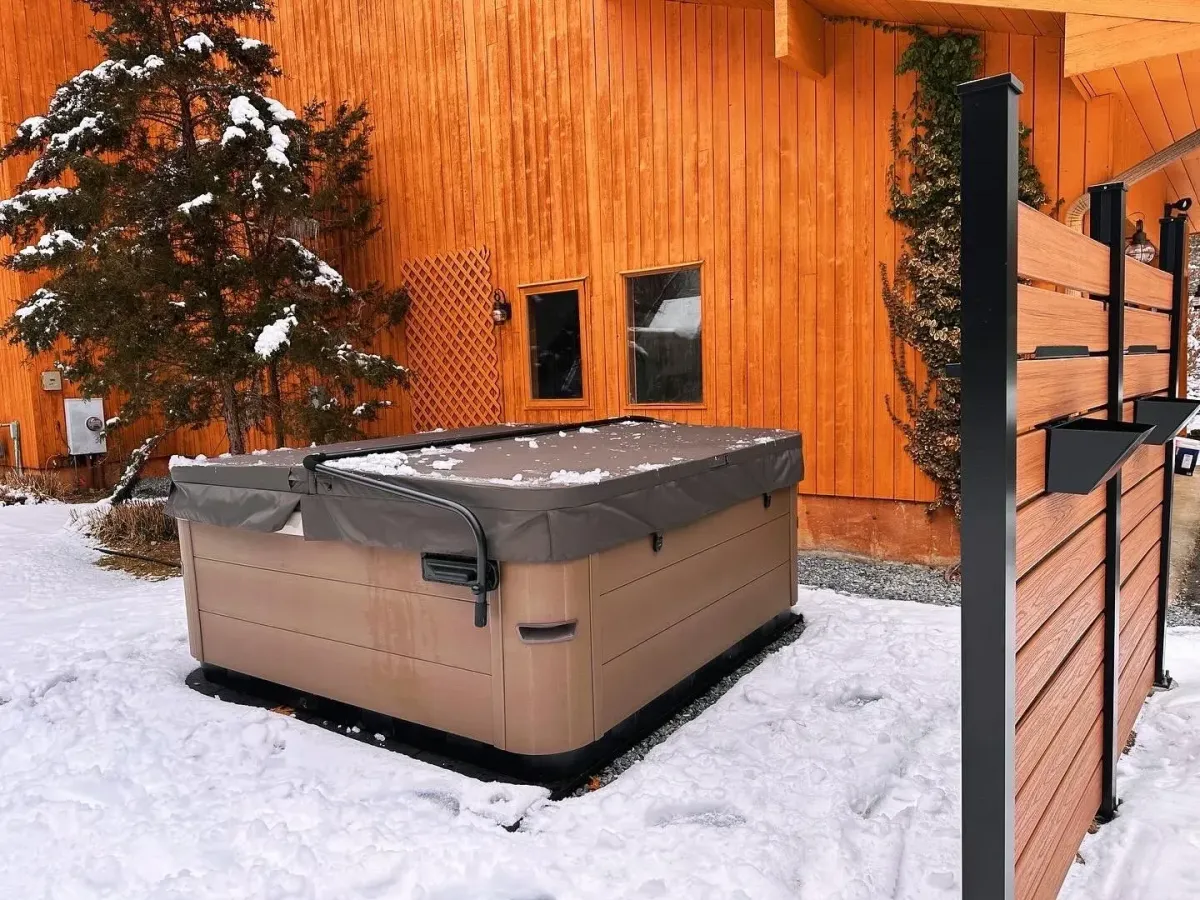 Modern chandelier lighting installation by Ryan Gath Electric inside a residential home office with bookshelves