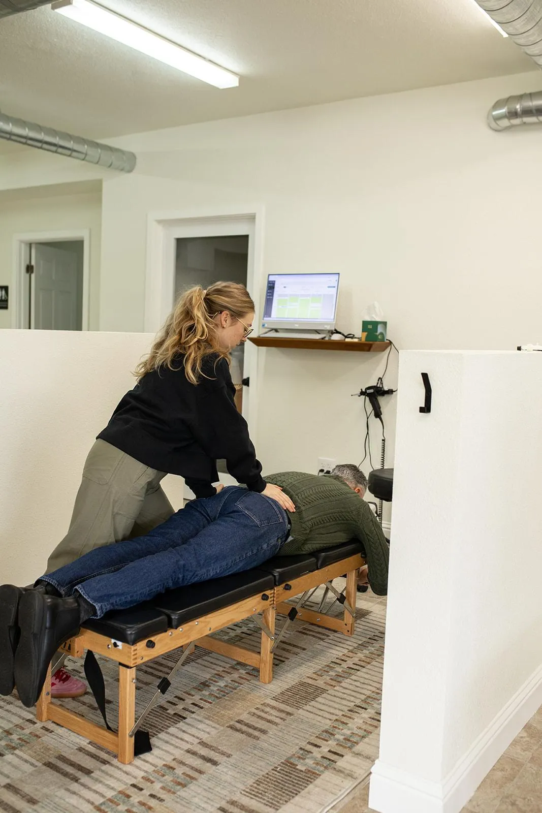 Patient receiving controlled chiropractic adjustment