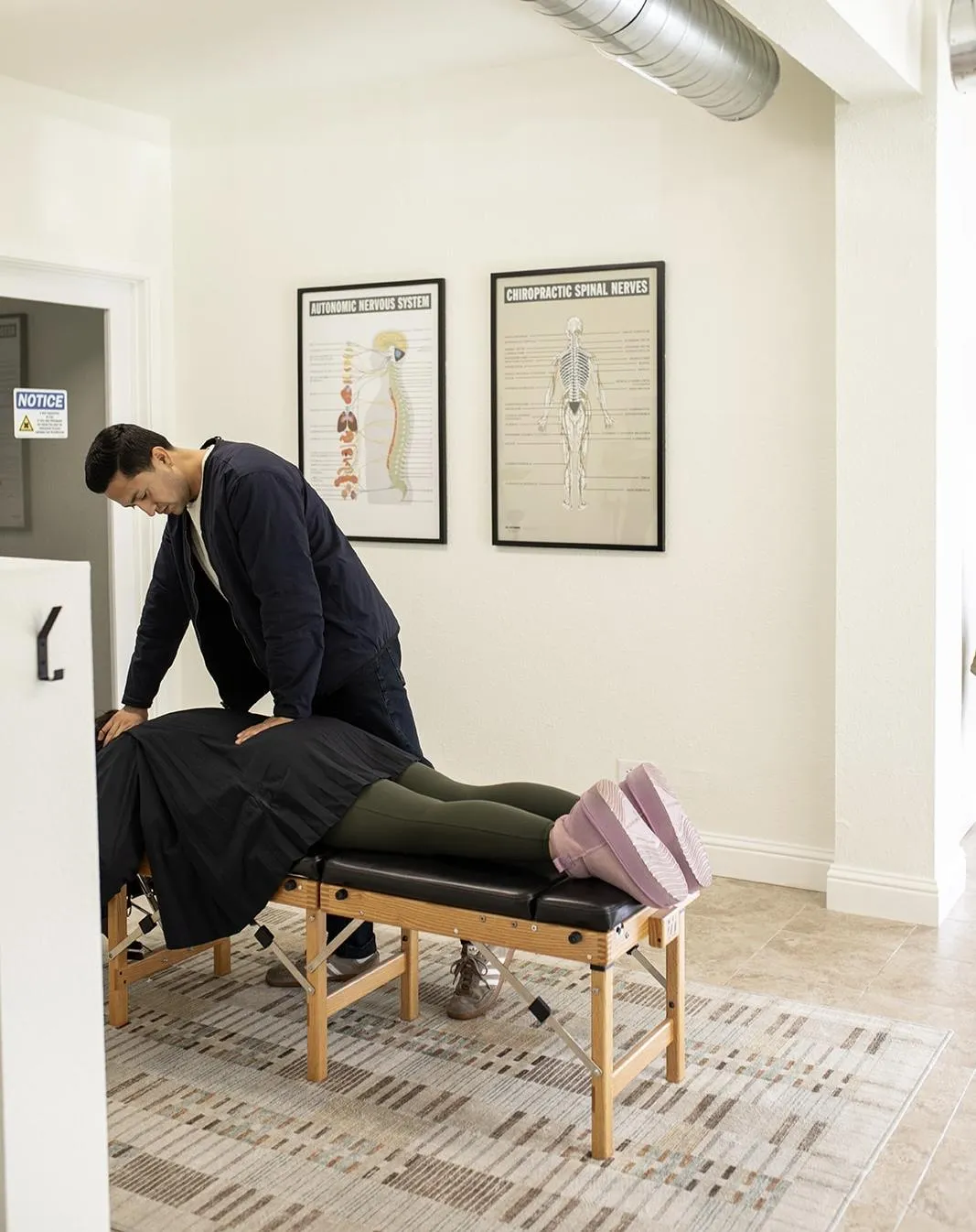 Chiropractor performing gentle manual adjustment on patient's neck