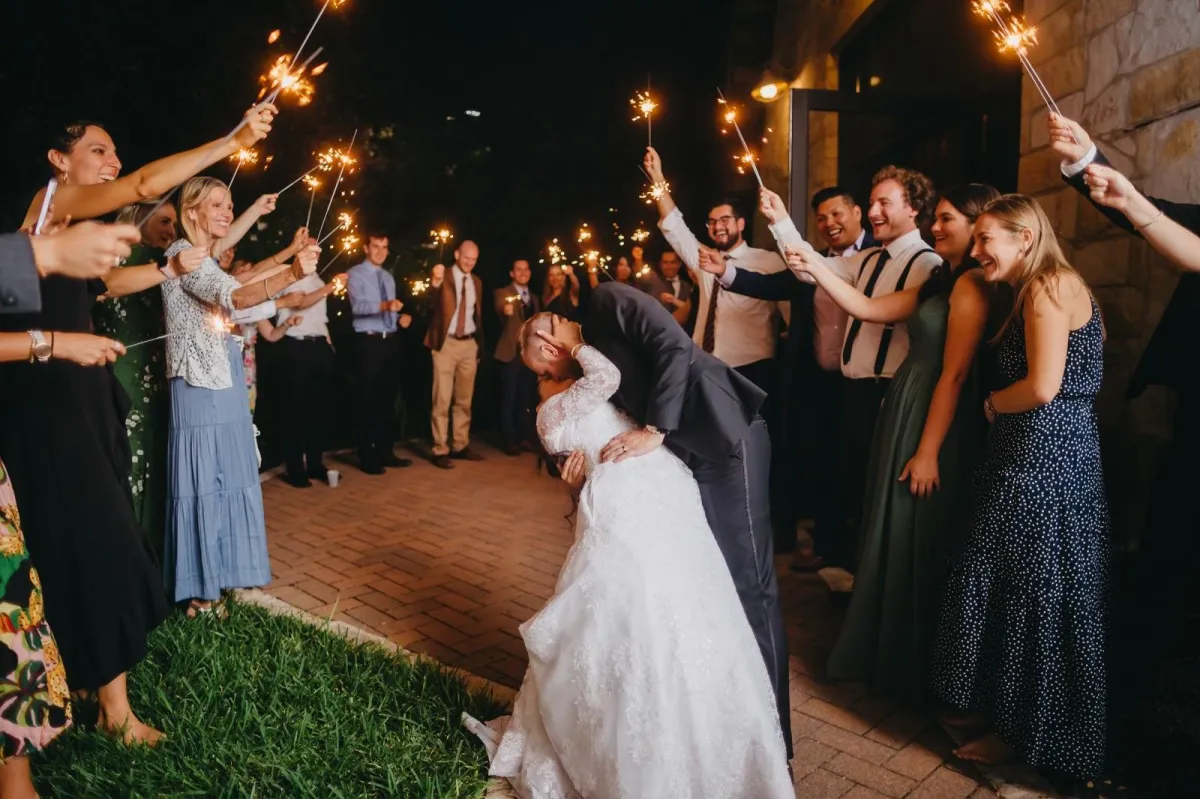 photo of smiling wedding coupe sitting inside vehicle