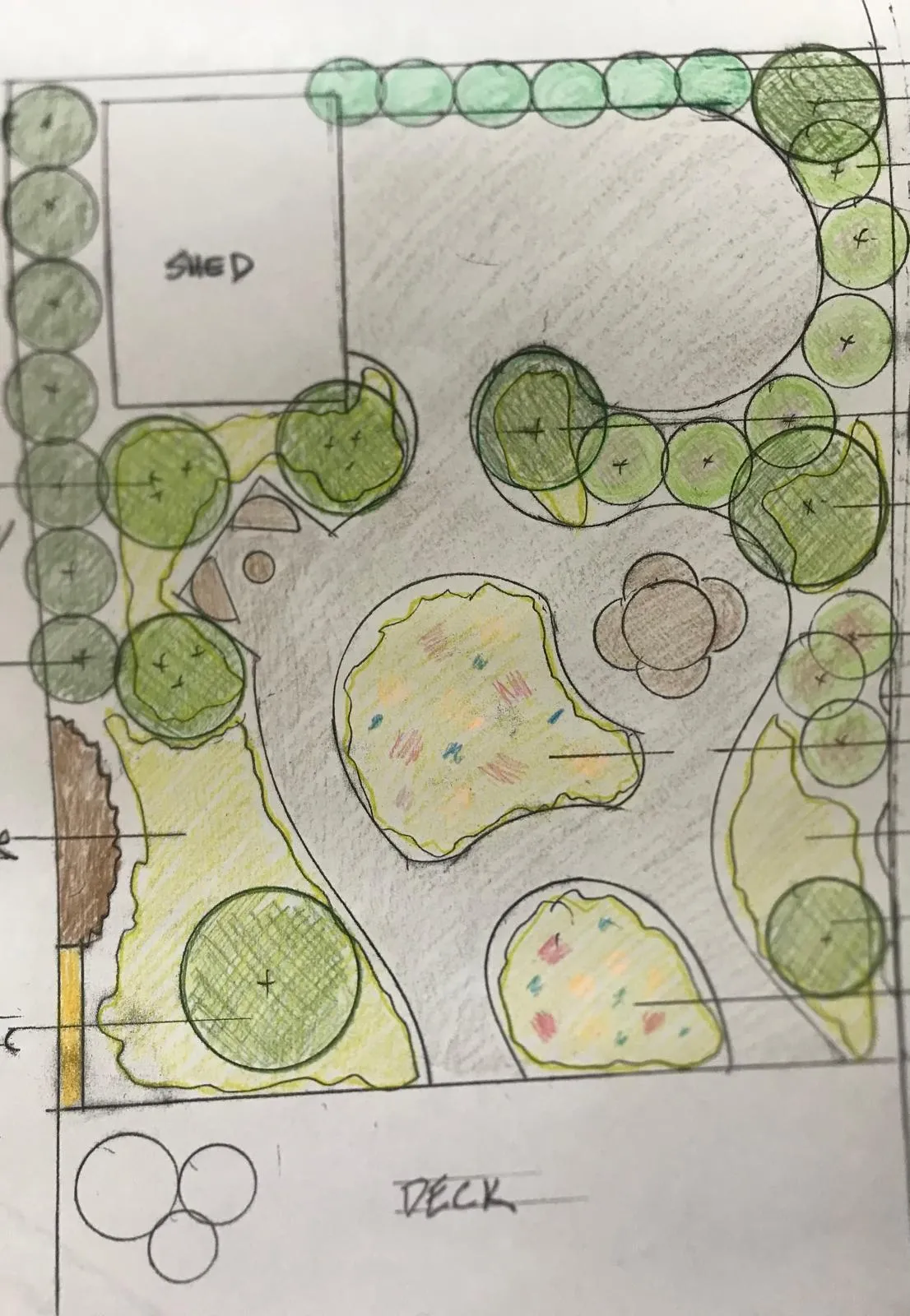 A hand-drawn and colored landscape design plan featuring a shed, pathways, trees, shrubs, and garden beds near a deck.