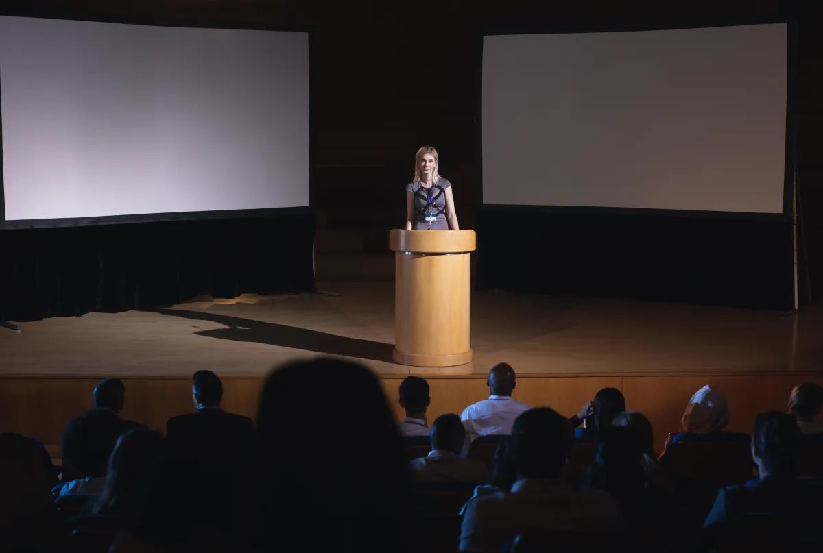 businesswoman-standing-around-podium