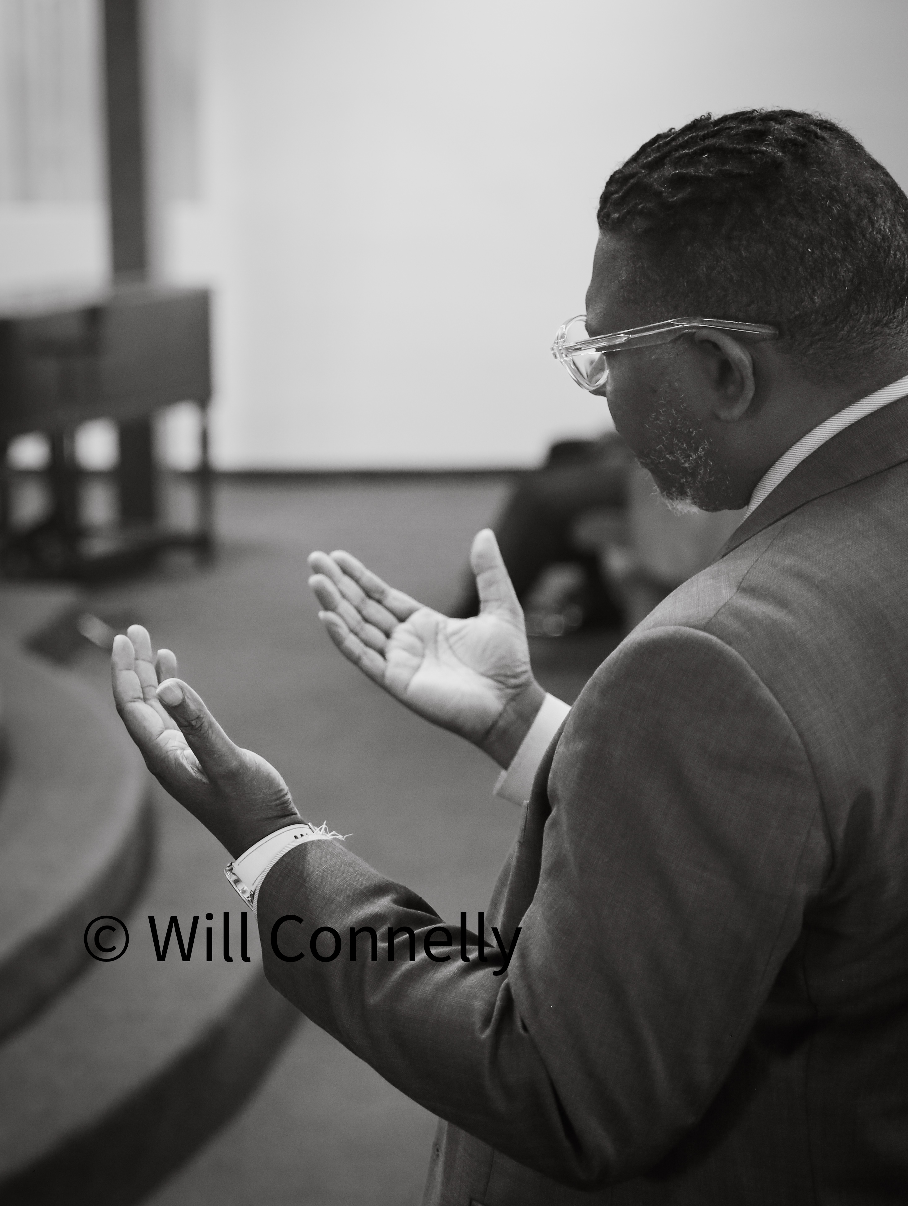 Pastor Roscoe Shields warmly greeting church members and visitors at Valley Crossroads