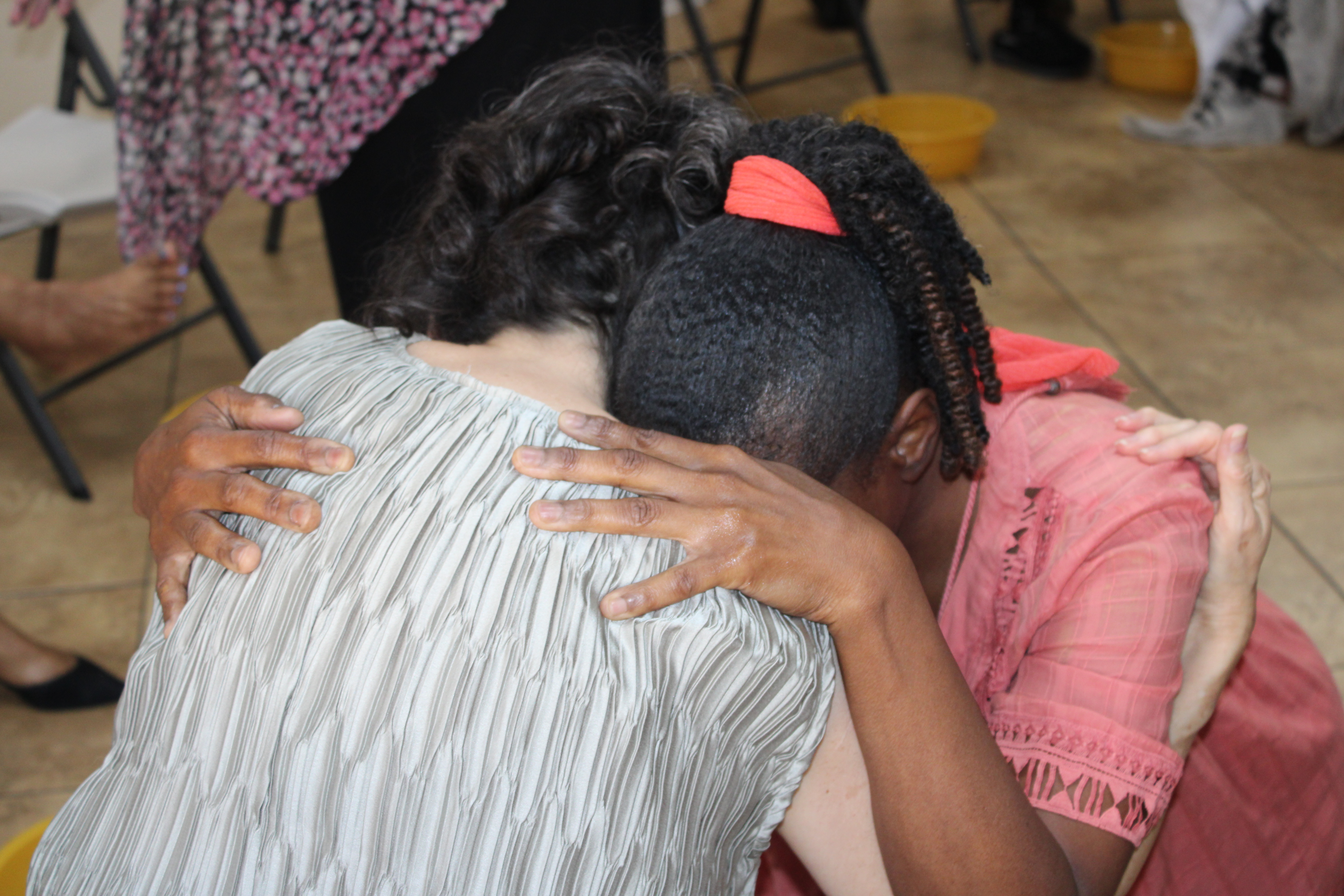 Warm documentary photo of genuine care, authentic conversation, and community support in a peaceful setting