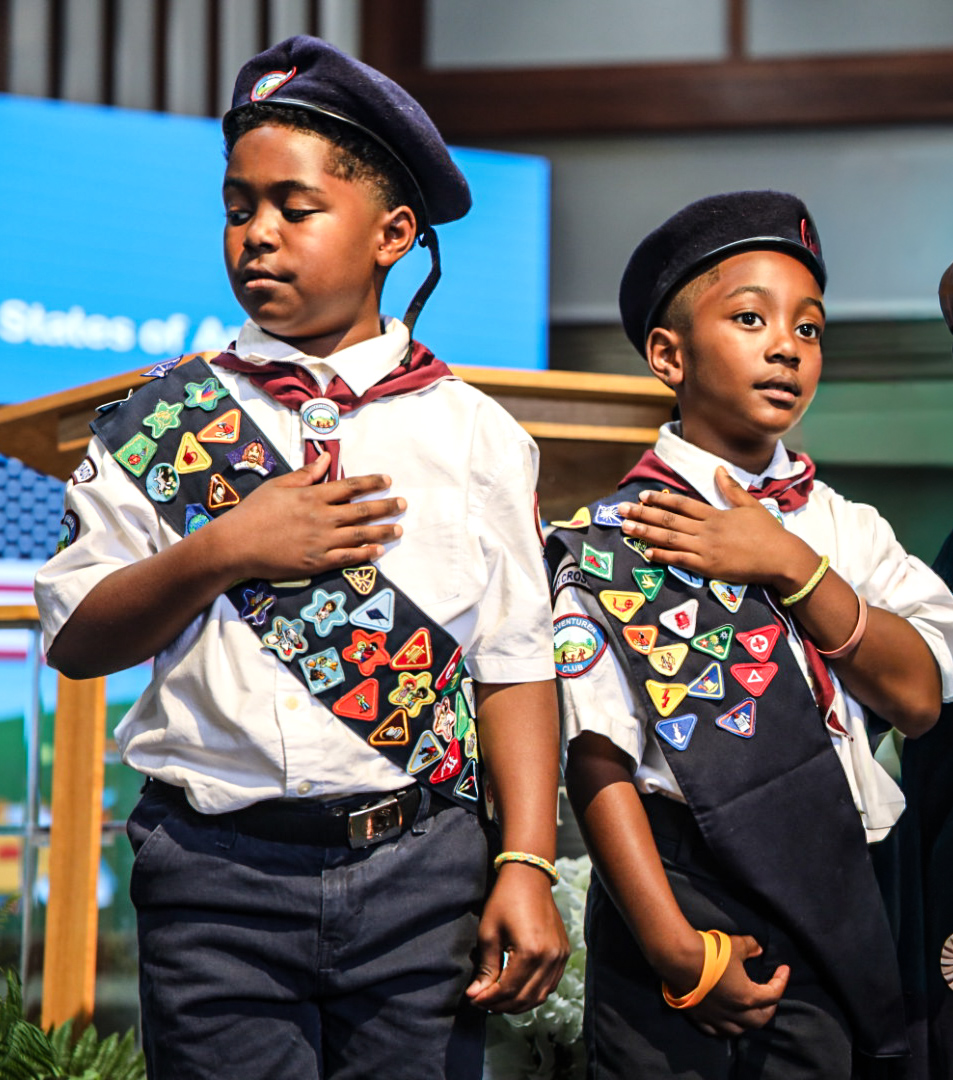 Documentary-style photo of children and families engaging together in Adventurer Club activities