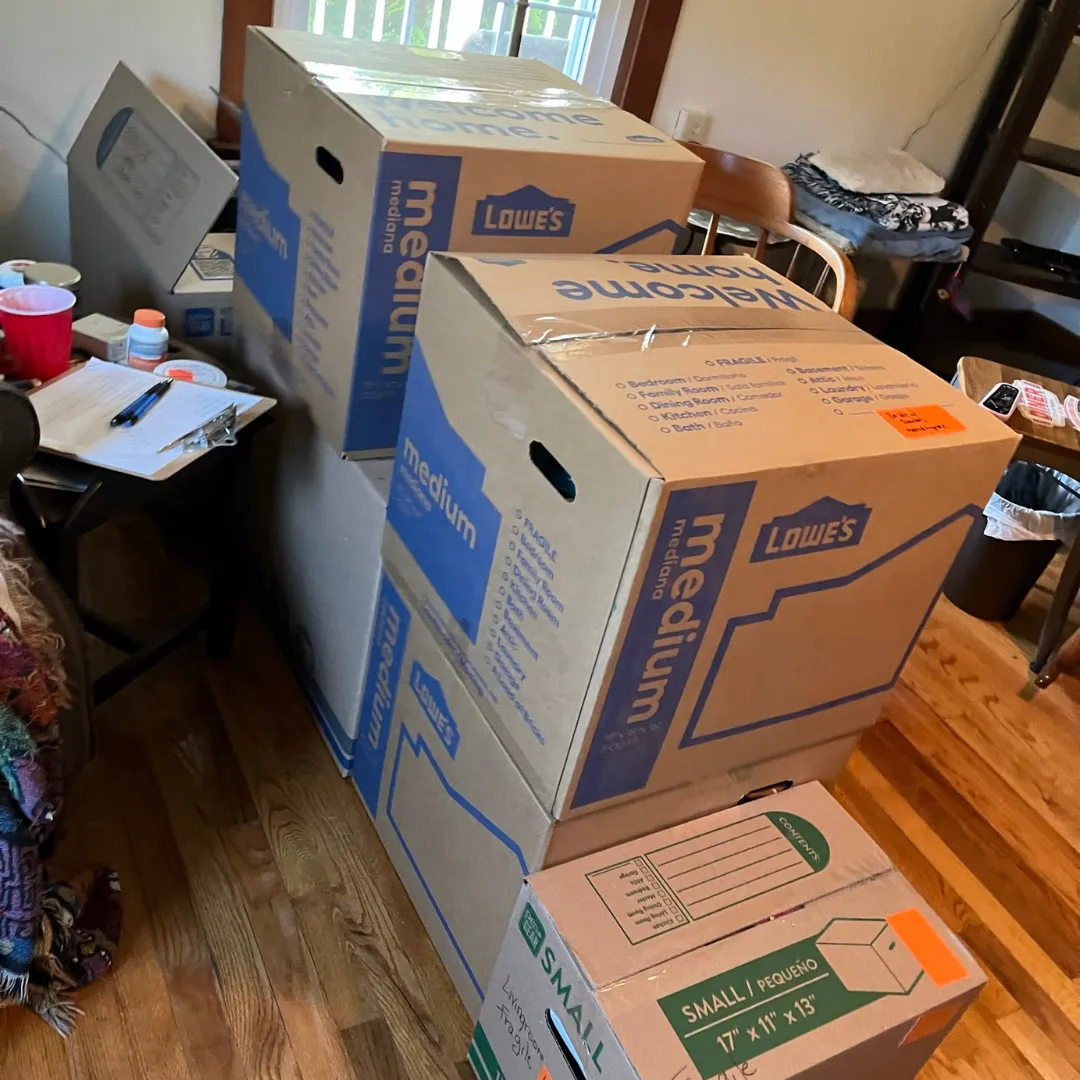 Bedroom full of moving boxes to unpack