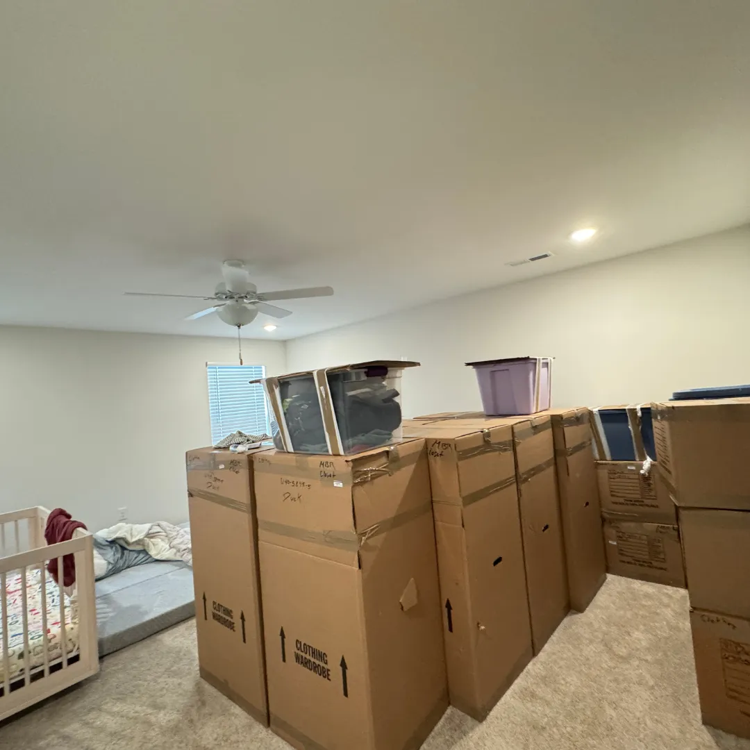 Bedroom full of moving boxes to unpack