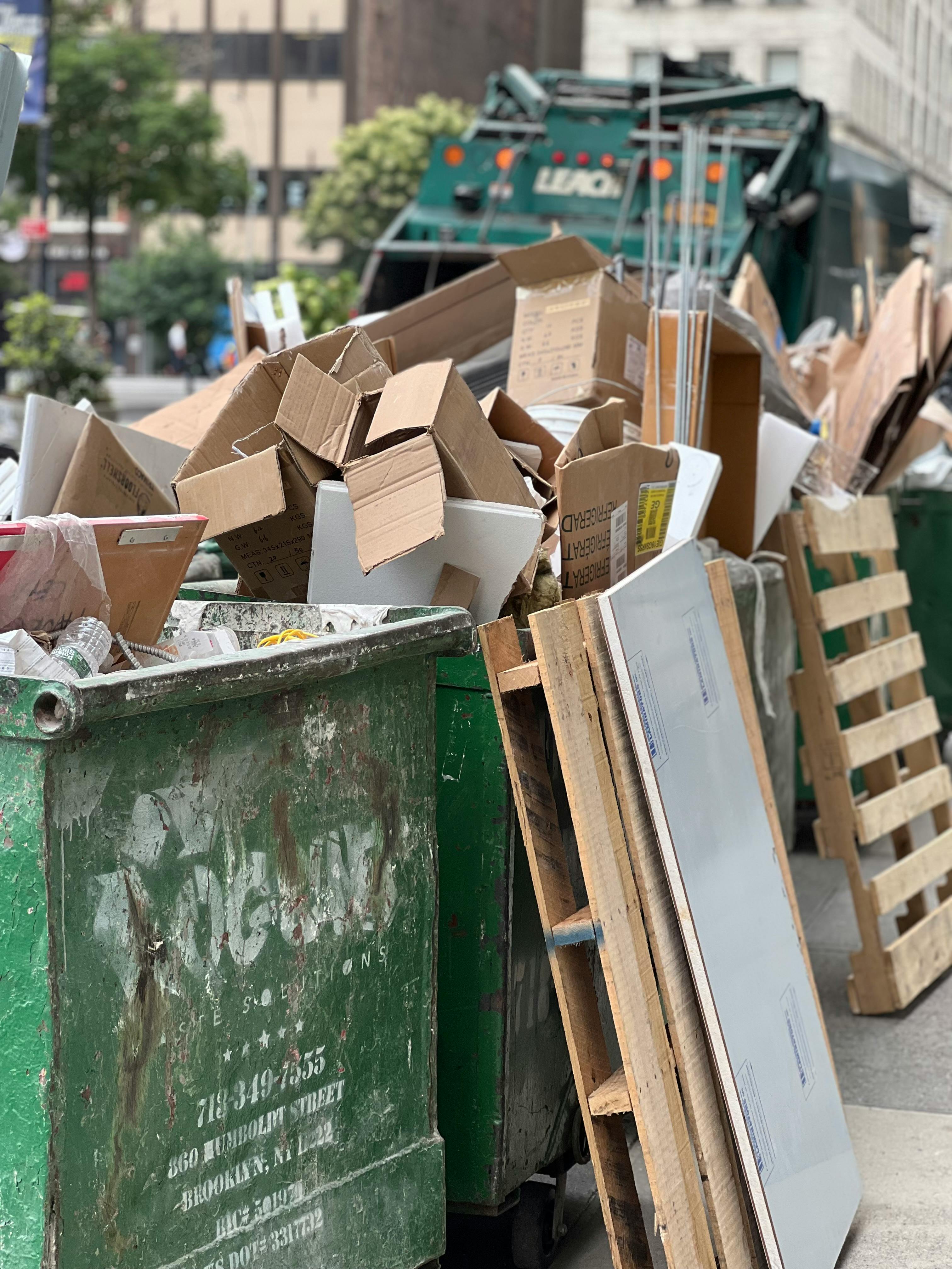 cardboard rubbish in commercial green skip bins