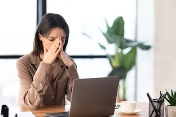 Photo of a frustrated female business owner using a laptop computer