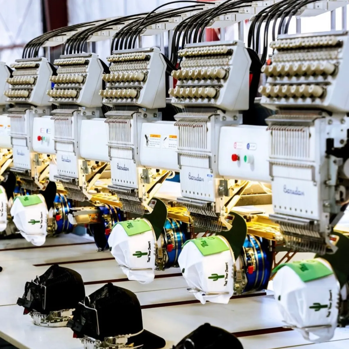 <img src="hats-on-embroidery-machine.jpg" alt="Custom hats being embroidered on the machine at 918Tees in Tulsa, Oklahoma, showcasing high-quality embroidery for businesses and events.">