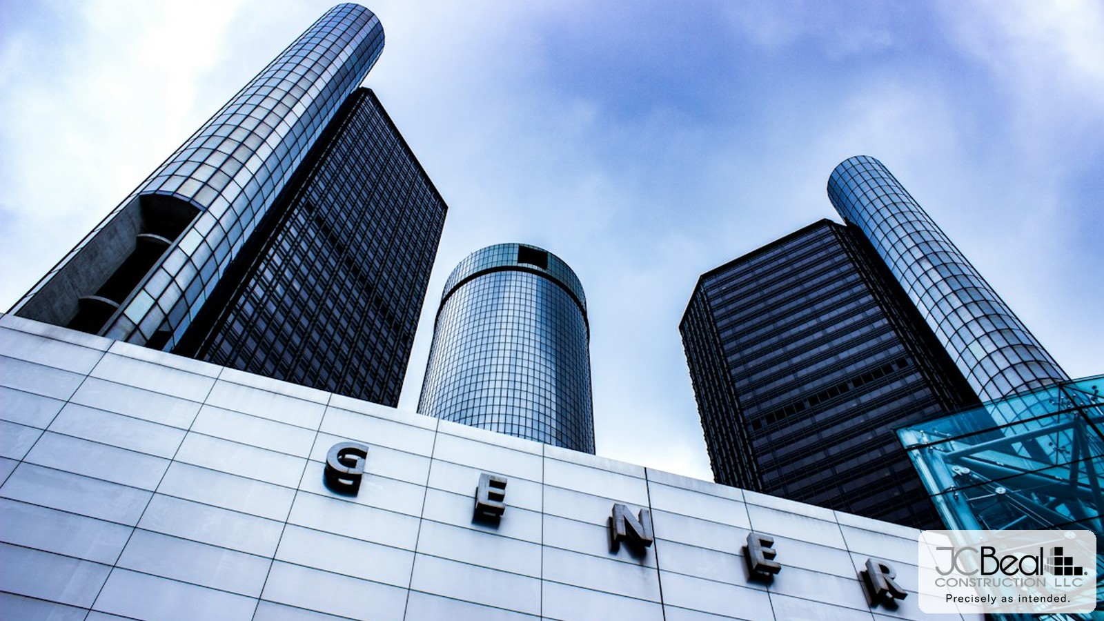 Low-angle view of downtown Detroit office towers against a blue sky