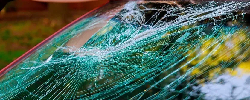 "Auto glass repair service in Miami, FL, with a technician fixing a vehicle's windshield."