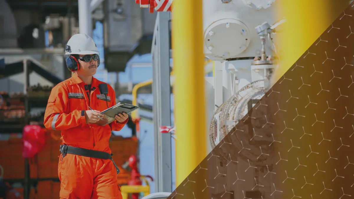 Man inspecting oil and gas operations for lubrication requirements