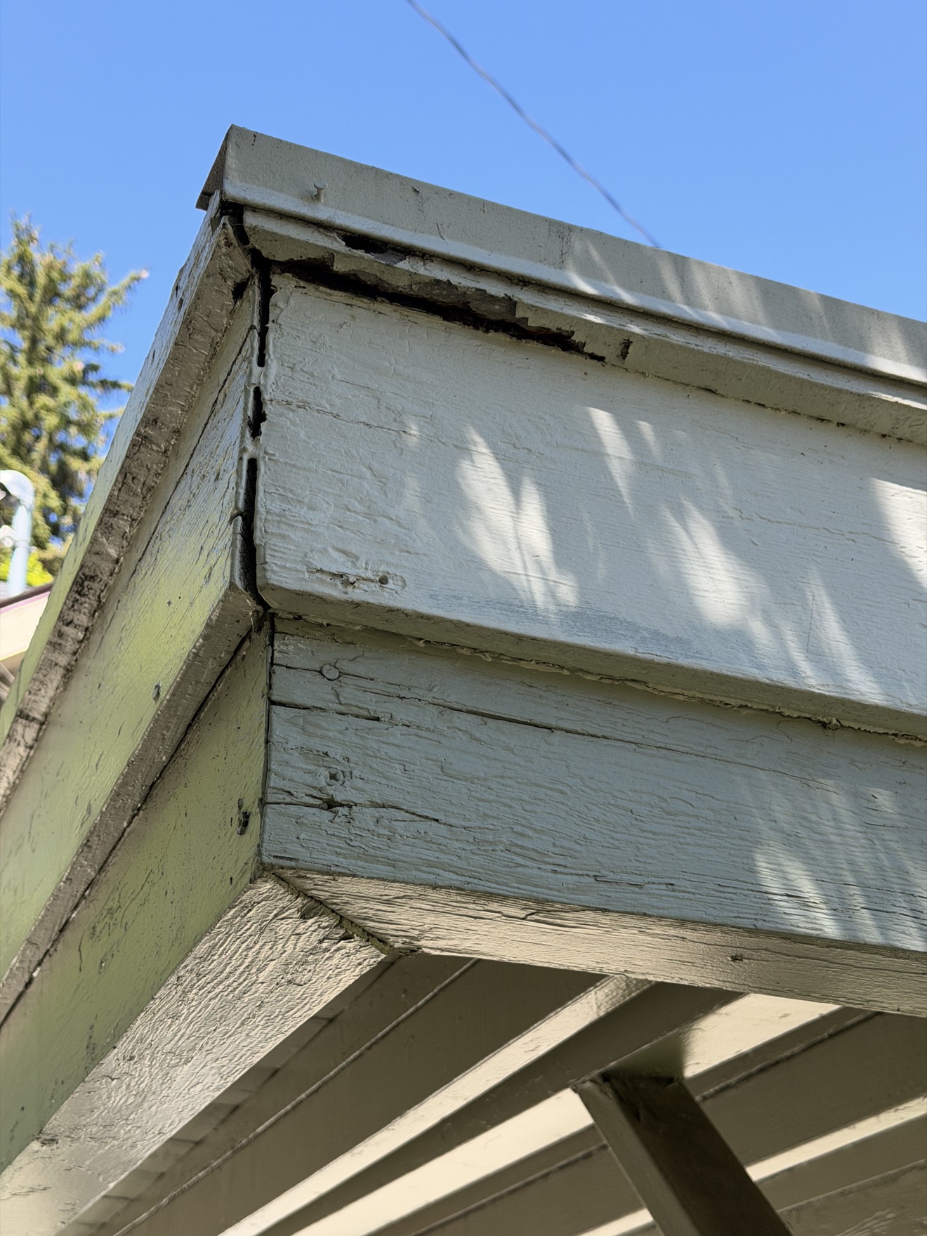 Close-up of worn fascia boards before repainting