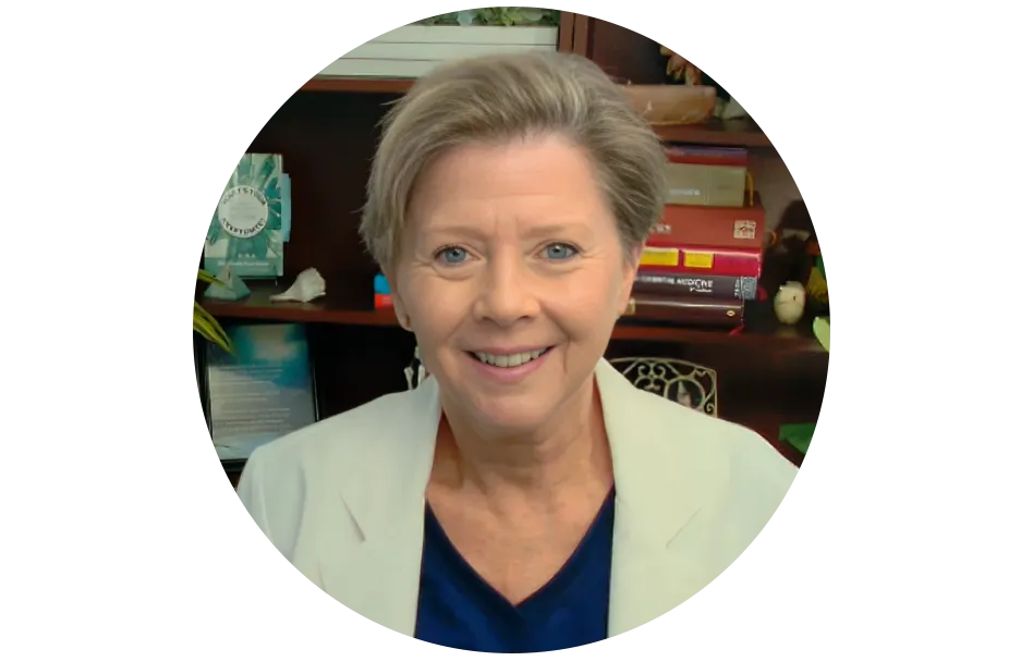 Warm, professional headshot of Dr. Gala in a softly lit clinic environment, smiling and approachable.