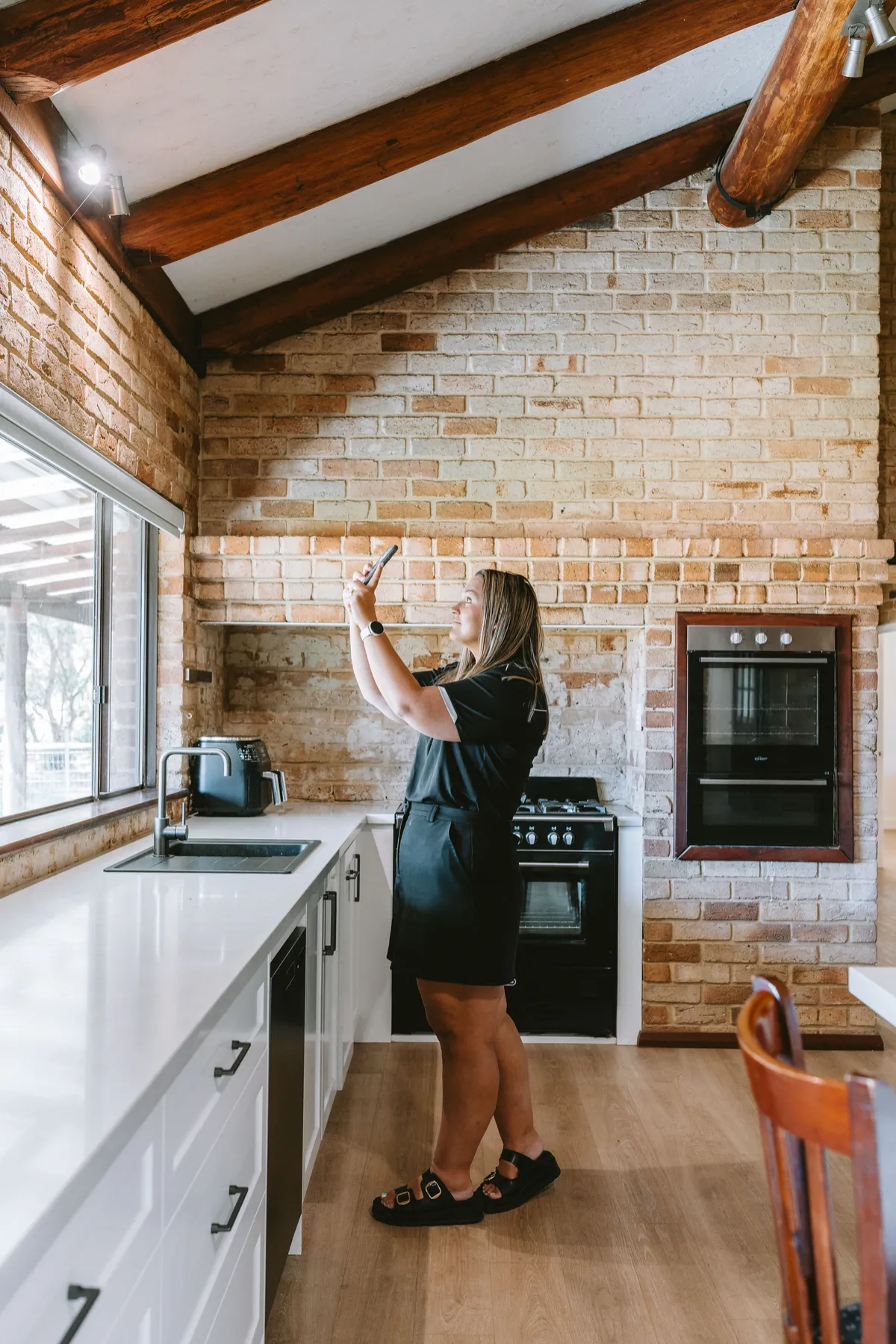 Alicia McCulloch, Director & Licensee of Thryve Property, photographing a kitchen