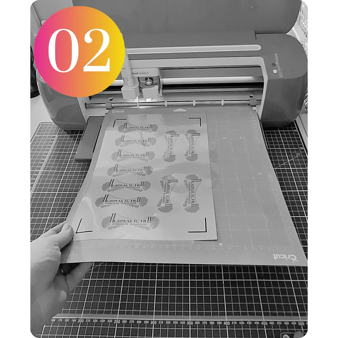 Image of a Cricut machine with a mat and holographic sticker sheet being inserted