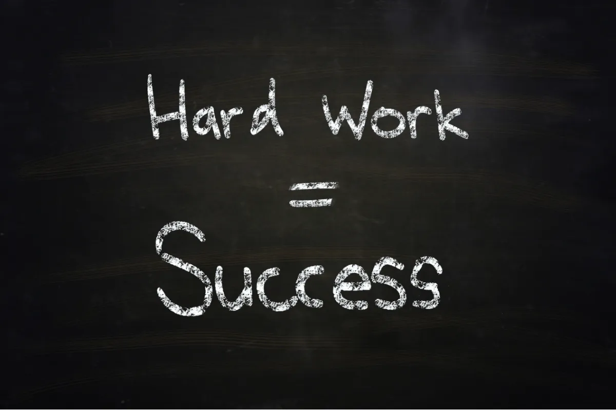 Hard Work = Success written on a board in chalk