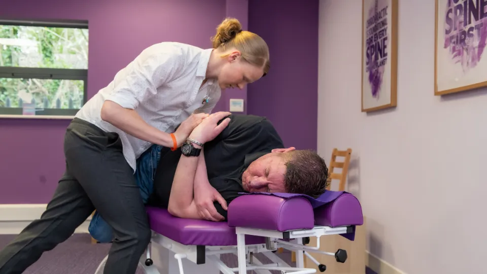 Chiropractor with patient