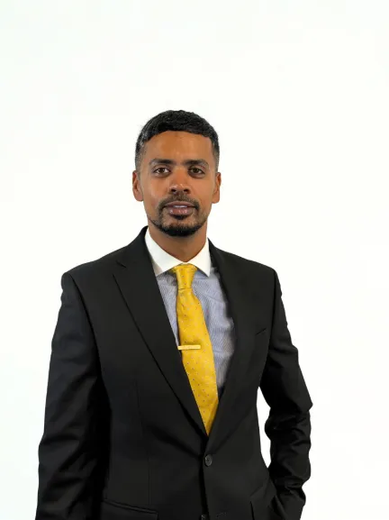 Jash Subhan, South Asian male, 30s, confident smile, business attire, standing in a modern office with city view, natural light