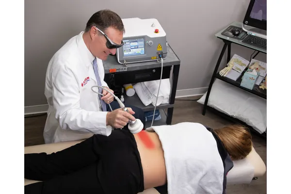 Dr. Folkerts using High Intensity Laser