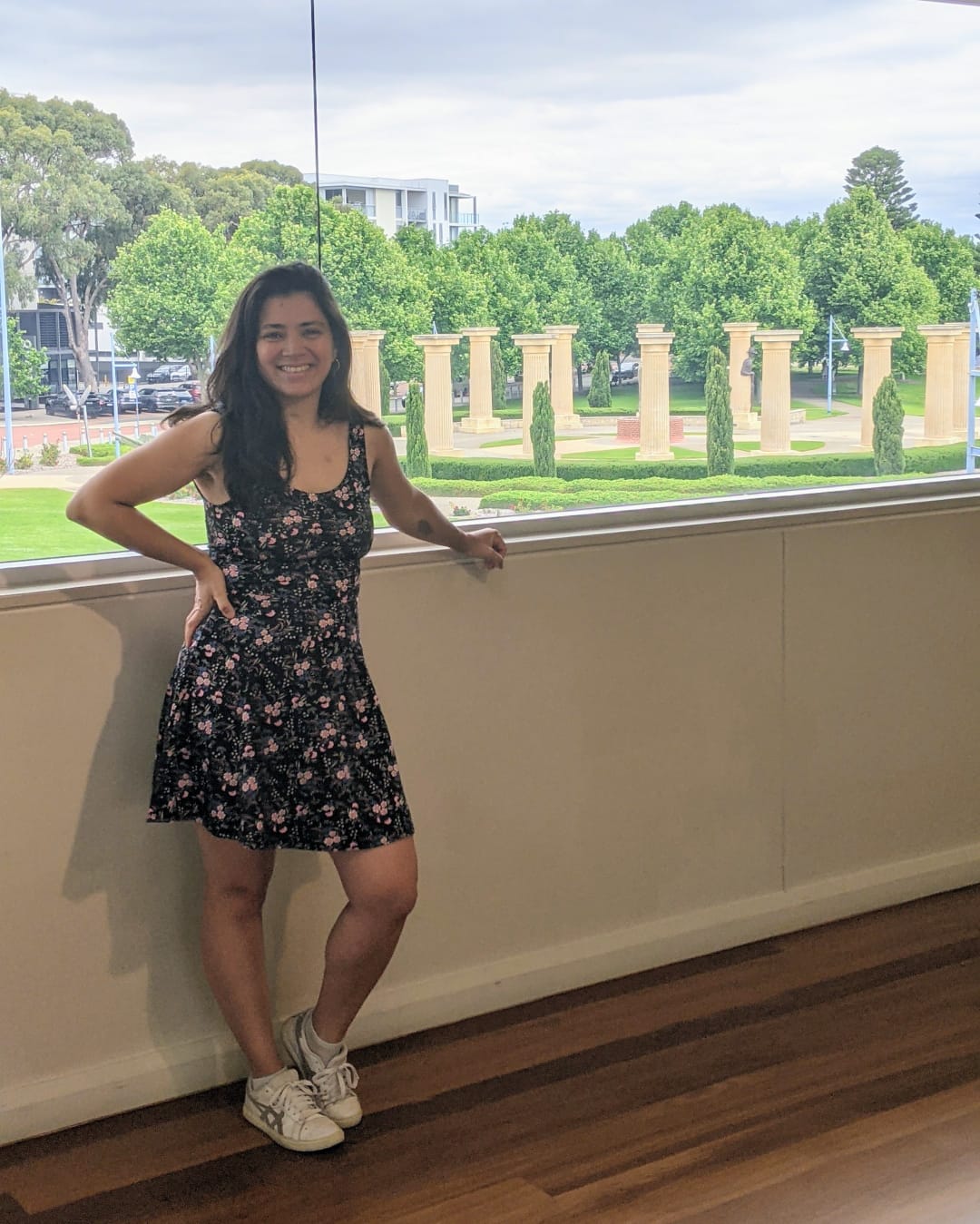 Instructor guiding participants through gentle Zumba steps in a bright, welcoming studio with chairs available.