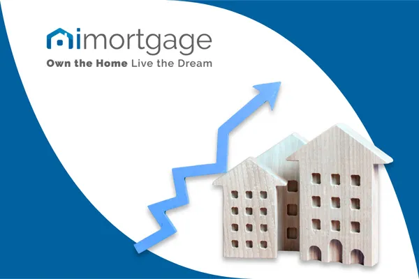 iMortgage blog header featuring wooden model houses and a blue rising trend arrow set against a white leaf-shaped graphic. Includes the IMortgage logo and 'Own the Home, Live the Dream' tagline on a navy blue background.