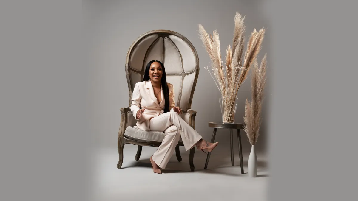 Editorial portrait of Qui Daugherty in a modern, neutral interior