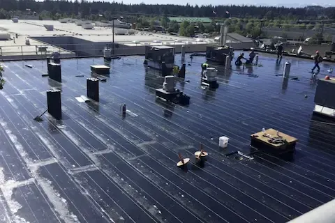 Commercial flat roof membrane installation underway by Brooklyn Park Commercial Roofing