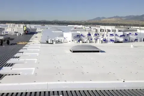 White membrane flat roof with rooftop HVAC units on large commercial facility in Brooklyn Park