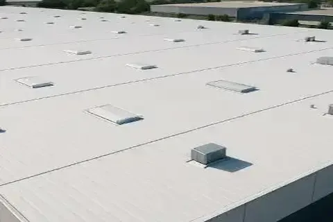 Aerial view of white membrane roof on industrial warehouse completed by Brooklyn Park Commercial Roofing