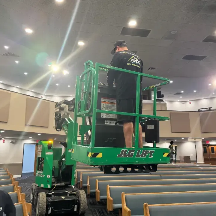 Apex technician on a lift servicing the ceiling of a commercial property in Orlando, FL
