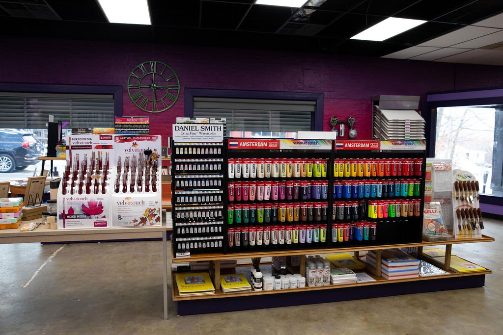 a photo of multiple shelves and paint selections on a shelf at IRiS Art Haus