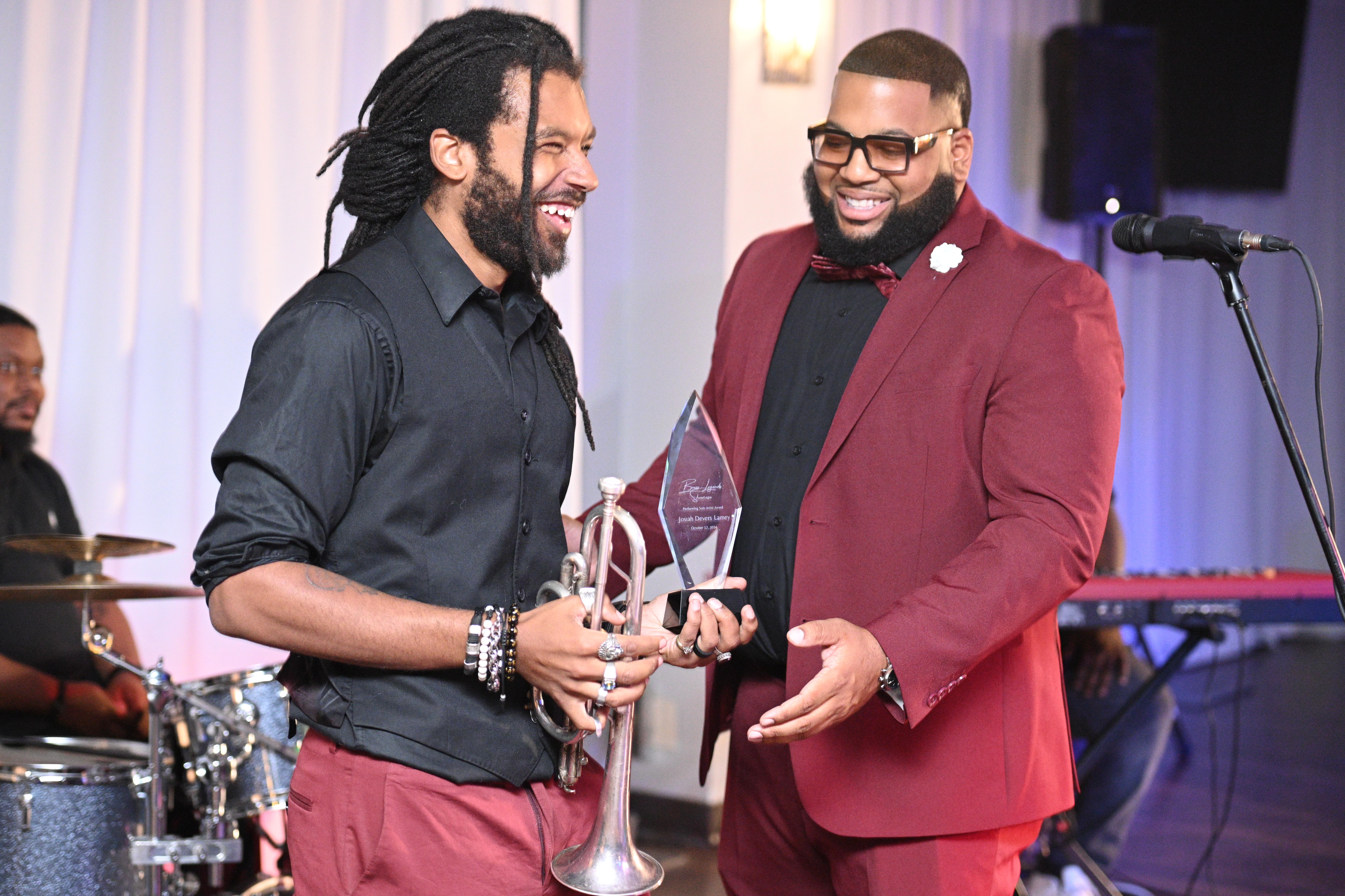 two men standing while welding