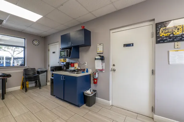 Person boarding a bus at the airport, carrying luggage.