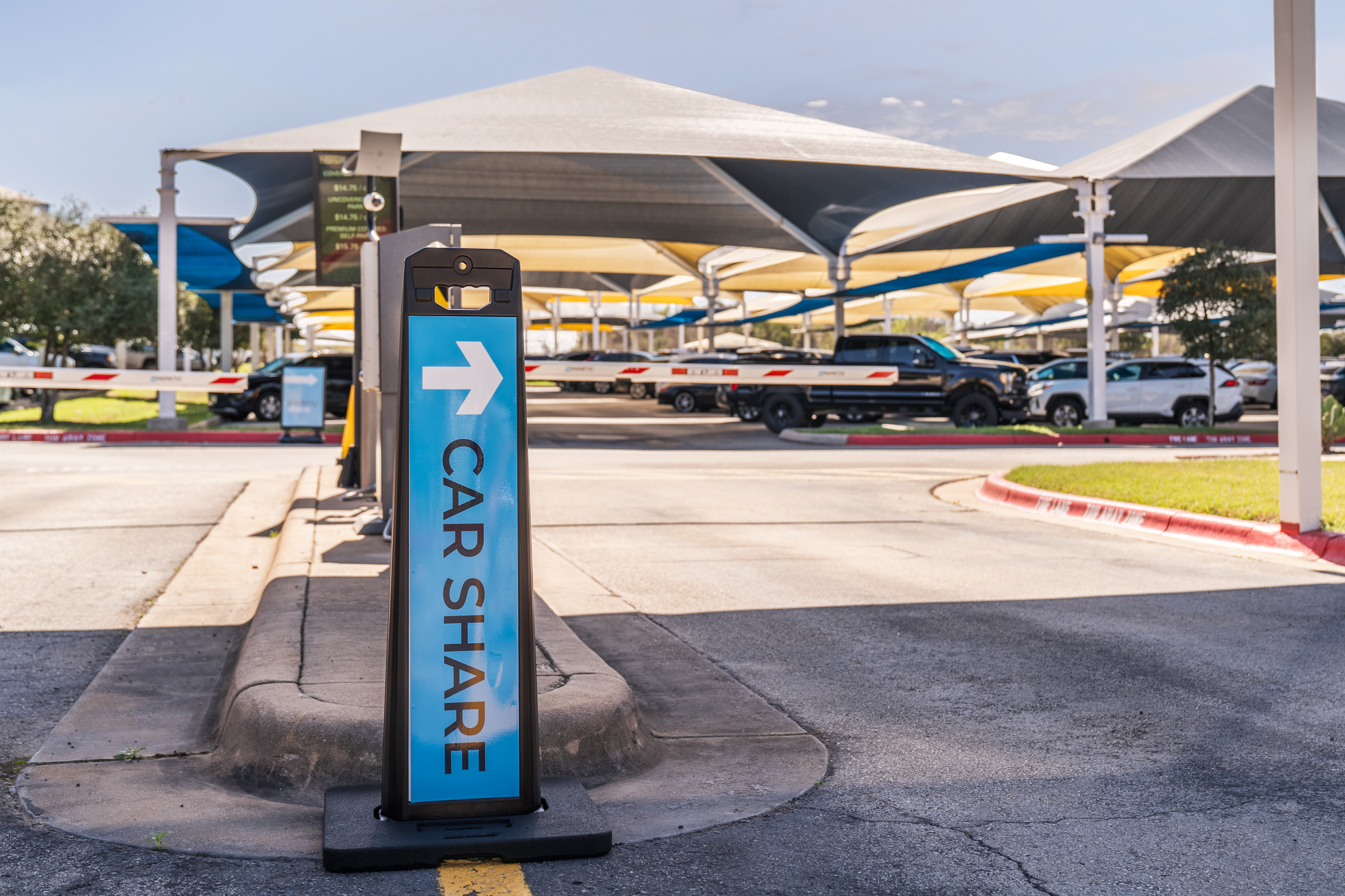Person boarding a bus at the airport, carrying luggage.