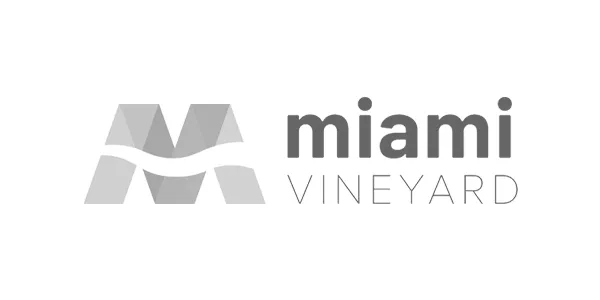 Logo of Miami Vineyard, featuring a stylized "M" and the text "miami VINEYARD," representing a church focused on community engagement and digital outreach.