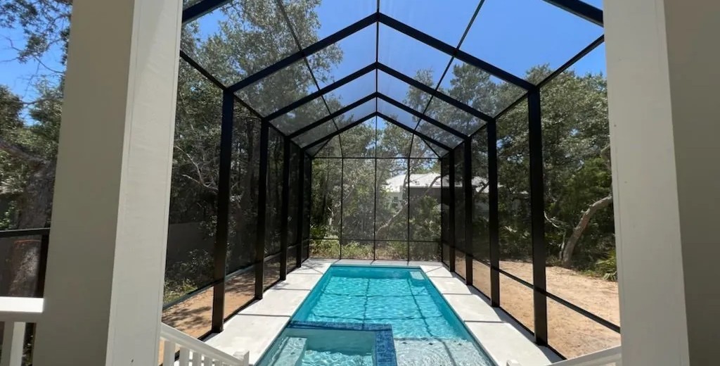 Finished bronze peak roof enclosure over a lap pool, built from its 3D model by Aluminum Building Systems in Santa Rosa Beach, FL