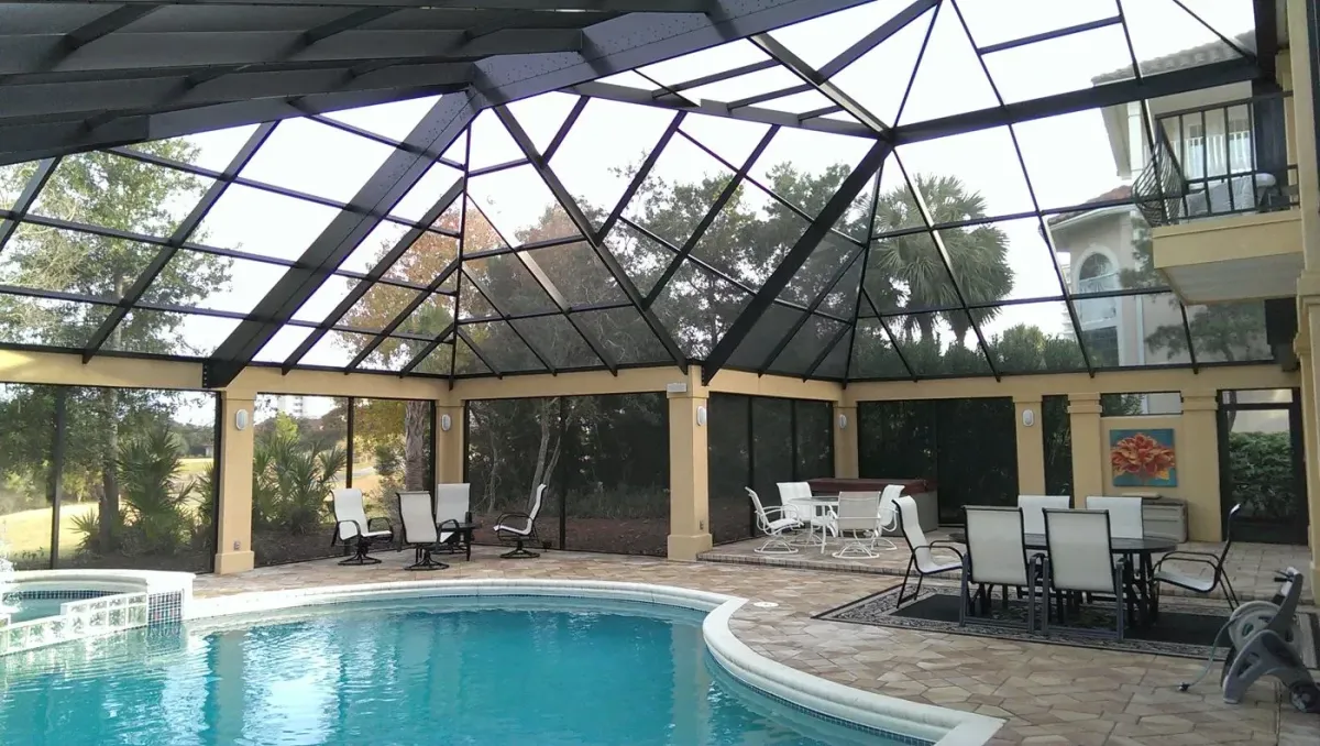 Bronze irregular custom mansard pool enclosure following the angles of the home, built by Aluminum Building Systems in Crestview, FL