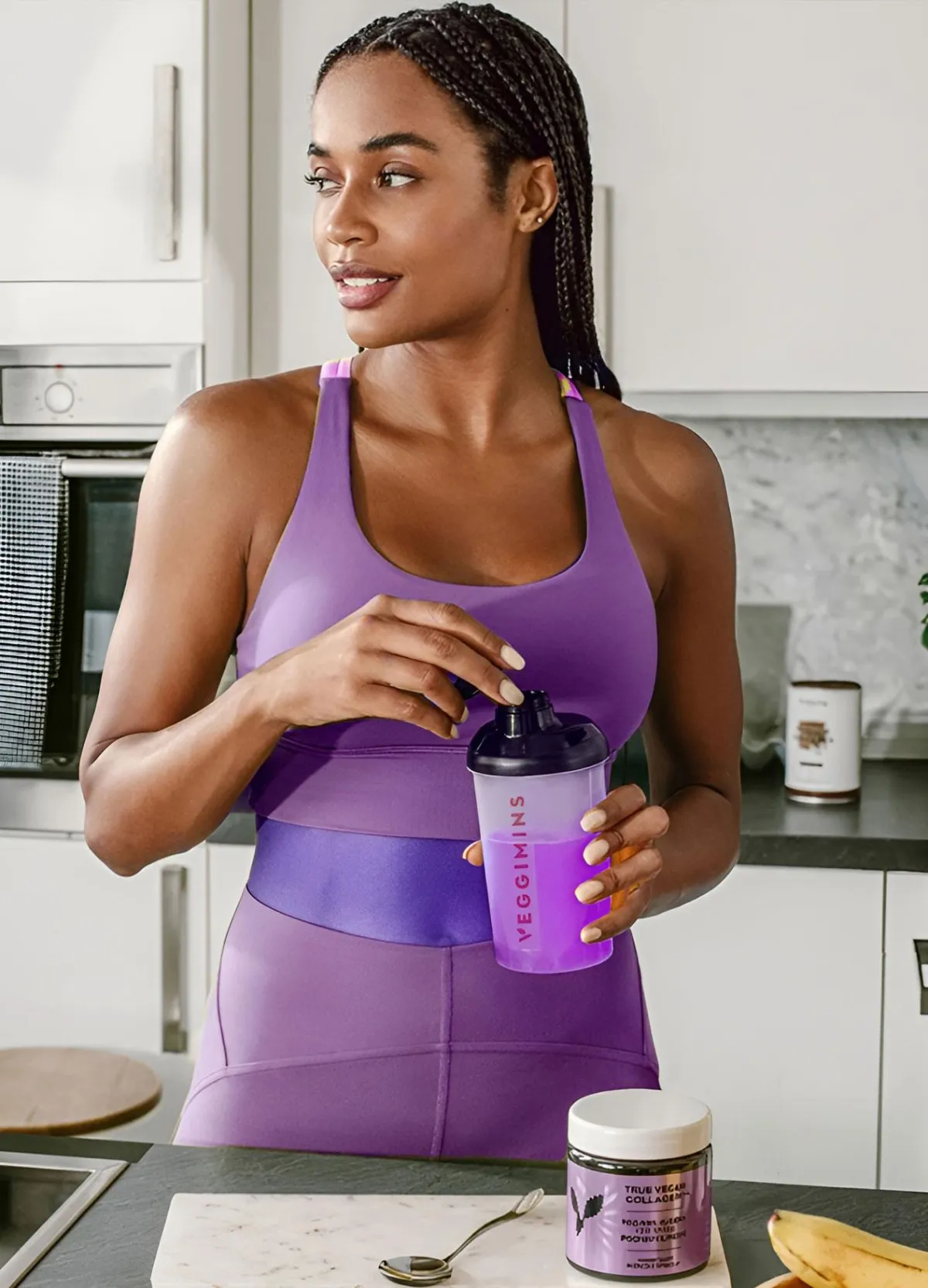Woman holding Veggimins Vegan Collagen Bottle