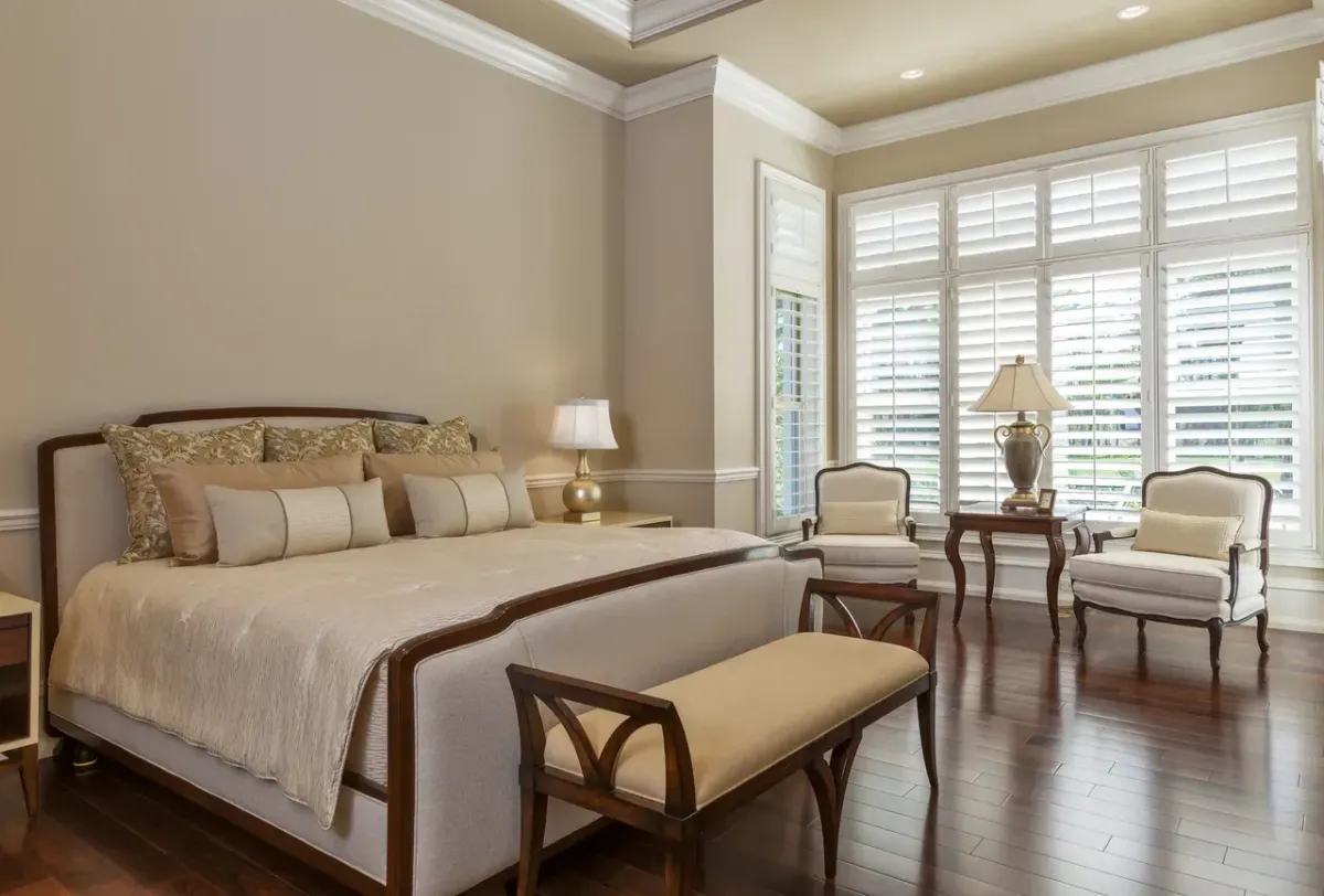 — Custom plantation shutters in Stuart, FL installed in a cozy bedroom for privacy